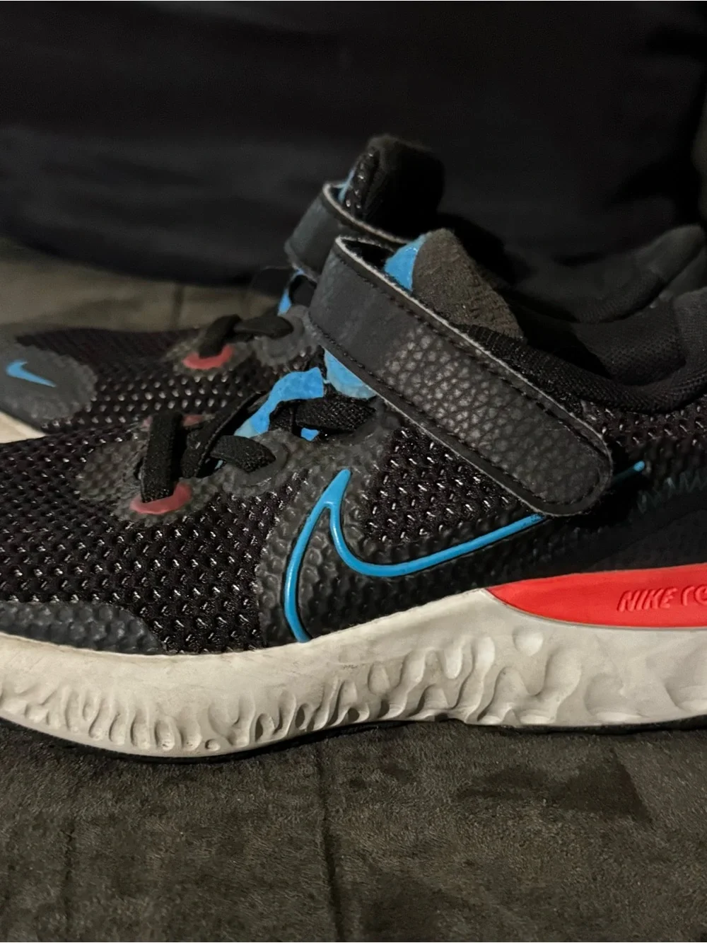 Renew Nike Kids size 13. Running Black Sneakers with Blue and neon pink .